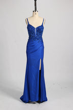 A woman with sleek dark hair and a poised stance wears a red, glittery gown. It has thin straps, beaded bodice, and a high side slit. Paired with silver heels, the outfit radiates elegance, perfect for formal events like galas, blending glamour and style.
8
