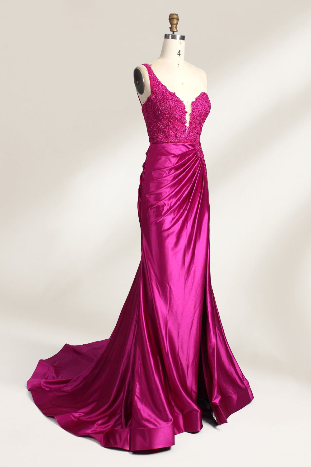 A mannequin displays a teal satin gown. It features a deep V - neckline with lace embroidery on the bodice, a ruched skirt, and a mermaid silhouette. The elegant details and shiny fabric create a glamorous look, perfect for formal events like proms or galas.11