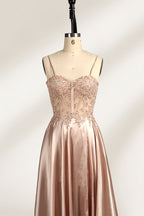 A mannequin showcases a champagne - satin gown. It has thin straps, a sheer lace - detailed bodice, and a voluminous skirt. The elegant design, blending satin and intricate lace, suits formal events like weddings, radiating sophistication.3