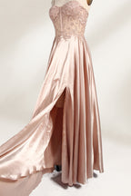 A mannequin showcases a champagne - satin gown. It has thin straps, a sheer lace - detailed bodice, and a voluminous skirt. The elegant design, blending satin and intricate lace, suits formal events like weddings, radiating sophistication.2