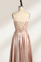 A mannequin showcases a champagne - satin gown. It has thin straps, a sheer lace - detailed bodice, and a voluminous skirt. The elegant design, blending satin and intricate lace, suits formal events like weddings, radiating sophistication.5