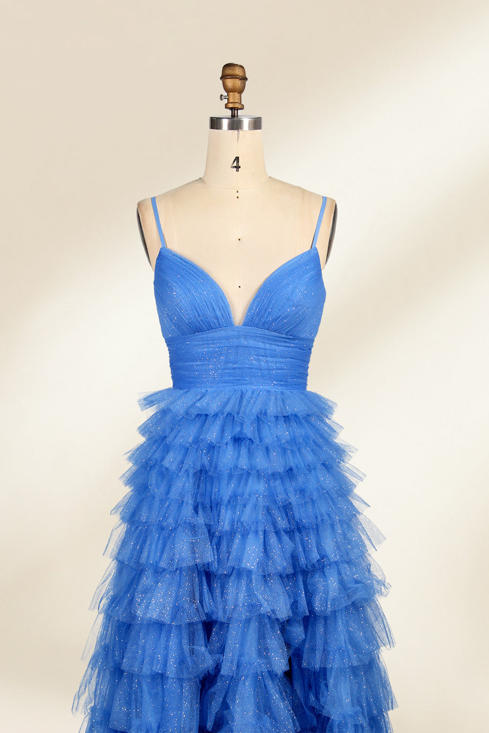 A mannequin showcases a light - blue tulle gown. It has thin straps, a V - neck, and tiered, ruffled skirt. The sparkling tulle and layered design add romance, perfect for formal events like weddings, radiating charm.2