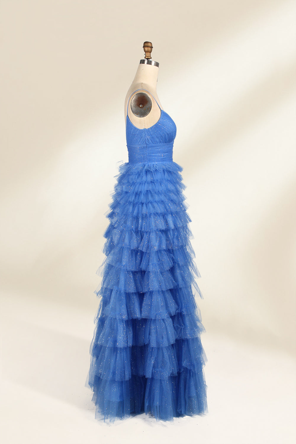 A mannequin showcases a light - blue tulle gown. It has thin straps, a V - neck, and tiered, ruffled skirt. The sparkling tulle and layered design add romance, perfect for formal events like weddings, radiating charm.4