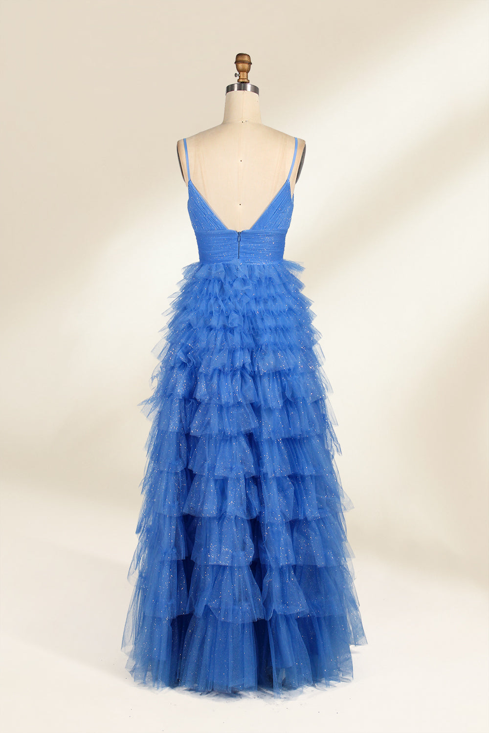 A mannequin showcases a light - blue tulle gown. It has thin straps, a V - neck, and tiered, ruffled skirt. The sparkling tulle and layered design add romance, perfect for formal events like weddings, radiating charm.5