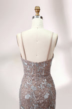 Showcased on a mannequin is a taupe - toned mermaid - cut gown. It has thin straps, a sweetheart neckline, and is embellished with delicate silver floral embroidery all over, plus a flowing tulle skirt. The refined design gives off a glamorous aura, ideal for formal events such as proms or weddings.5