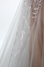 Showcased on a mannequin is a taupe - toned mermaid - cut gown. It has thin straps, a sweetheart neckline, and is embellished with delicate silver floral embroidery all over, plus a flowing tulle skirt. The refined design gives off a glamorous aura, ideal for formal events such as proms or weddings.6 