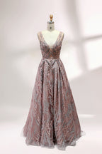 Presented on a mannequin is a mauve evening gown. It features a deep V - neckline, intricate floral embroidery with bead accents, and a flowing skirt. The elegant design creates a romantic and sophisticated look, perfect for formal events.1