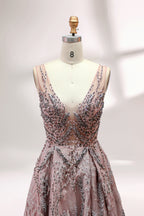 Presented on a mannequin is a mauve evening gown. It features a deep V - neckline, intricate floral embroidery with bead accents, and a flowing skirt. The elegant design creates a romantic and sophisticated look, perfect for formal events.4