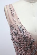 Presented on a mannequin is a mauve evening gown. It features a deep V - neckline, intricate floral embroidery with bead accents, and a flowing skirt. The elegant design creates a romantic and sophisticated look, perfect for formal events.6