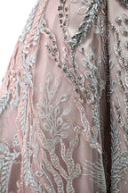 Presented on a mannequin is a mauve evening gown. It features a deep V - neckline, intricate floral embroidery with bead accents, and a flowing skirt. The elegant design creates a romantic and sophisticated look, perfect for formal events.7