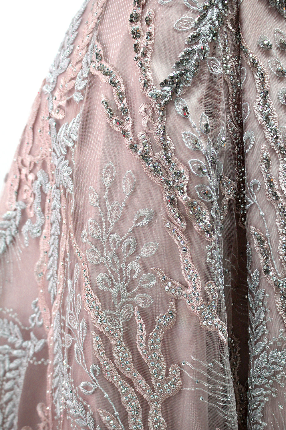Presented on a mannequin is a mauve evening gown. It features a deep V - neckline, intricate floral embroidery with bead accents, and a flowing skirt. The elegant design creates a romantic and sophisticated look, perfect for formal events.7