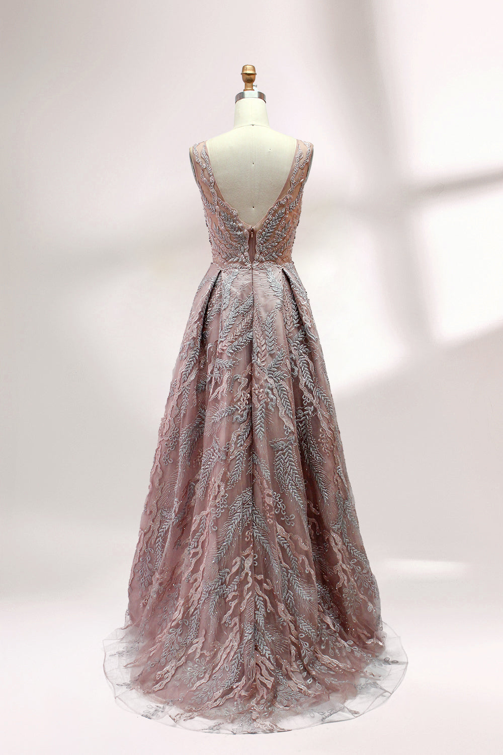 Presented on a mannequin is a mauve evening gown. It features a deep V - neckline, intricate floral embroidery with bead accents, and a flowing skirt. The elegant design creates a romantic and sophisticated look, perfect for formal events.2