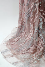 Presented on a mannequin is a mauve evening gown. It features a deep V - neckline, intricate floral embroidery with bead accents, and a flowing skirt. The elegant design creates a romantic and sophisticated look, perfect for formal events.8