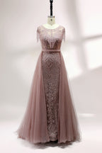 Displayed on a mannequin is a silver - gray evening gown. It features a sheer neckline with fringe details, intricate lace embroidery on the bodice, and a flowing tulle overlay. The elegant design creates a sophisticated and glamorous look, perfect for formal events.3