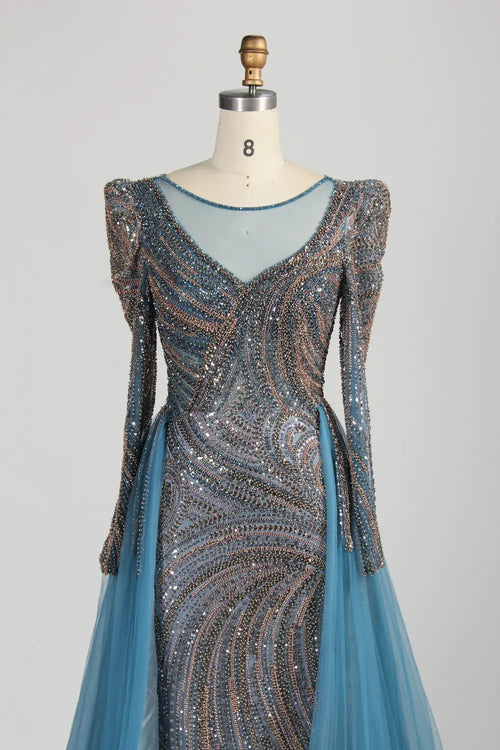 Dusty blue mermaid gown with long sleeves, deep V neckline, and beaded shimmer