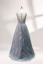 Presented on a mannequin is a gown with a gray base and rich red floral embroidery. It features a sheer neckline, a sleeveless design, and an intricate pattern that gives off a romantic and elegant vibe, perfect for formal events.2