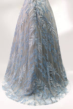 Presented on a mannequin is a gown with a gray base and rich red floral embroidery. It features a sheer neckline, a sleeveless design, and an intricate pattern that gives off a romantic and elegant vibe, perfect for formal events.9