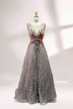 Presented on a mannequin is a gown with a gray base and rich red floral embroidery. It features a sheer neckline, a sleeveless design, and an intricate pattern that gives off a romantic and elegant vibe, perfect for formal events.4