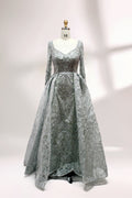 Showcased on a mannequin is a silver - gray evening gown. It has a V - neckline, long sleeves, and intricate lace embroidery all over. The elaborate design gives off a luxurious and elegant vibe, ideal for formal occasions.1
