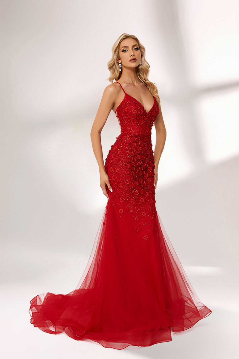 photo of beautiful blonde woman wearing elegant red evening gown with sequins, long fitted dress with sheer tulle skirt, standing in front of white background with soft shadows, light skin tone, wavy hair, red lipstick, confident pose, glamorous, high fashion, studio lighting, full body shot, no accessories except earrings, modern and chic style, full-length shot.KT1278C-01