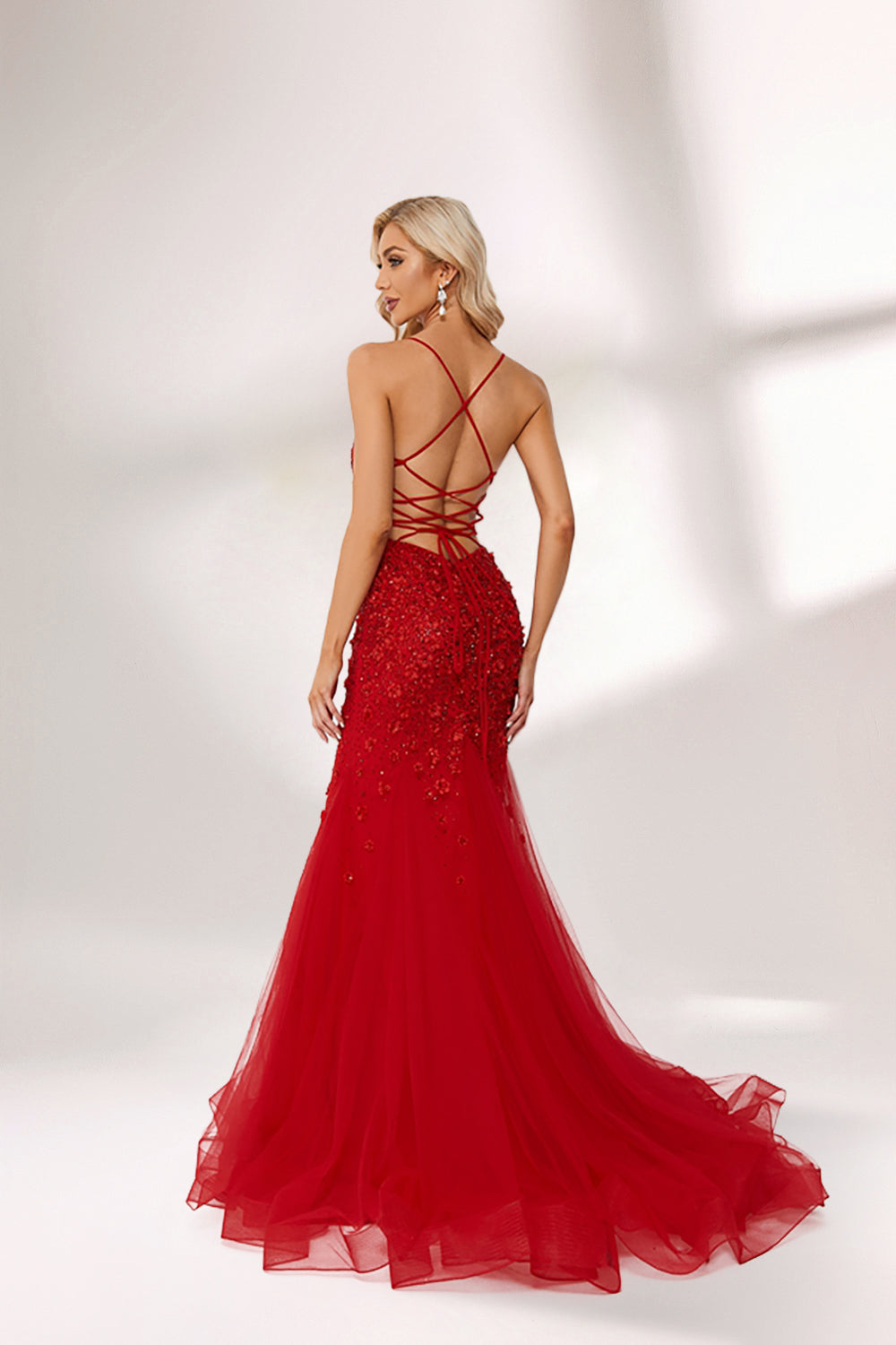 photo of beautiful blonde woman wearing elegant red evening gown with sequins, long fitted dress with sheer tulle skirt, standing in front of white background with soft shadows, light skin tone, wavy hair, red lipstick, confident pose, glamorous, high fashion, studio lighting, full body shot, no accessories except earrings, modern and chic style, full-length shot.KT1278C-02