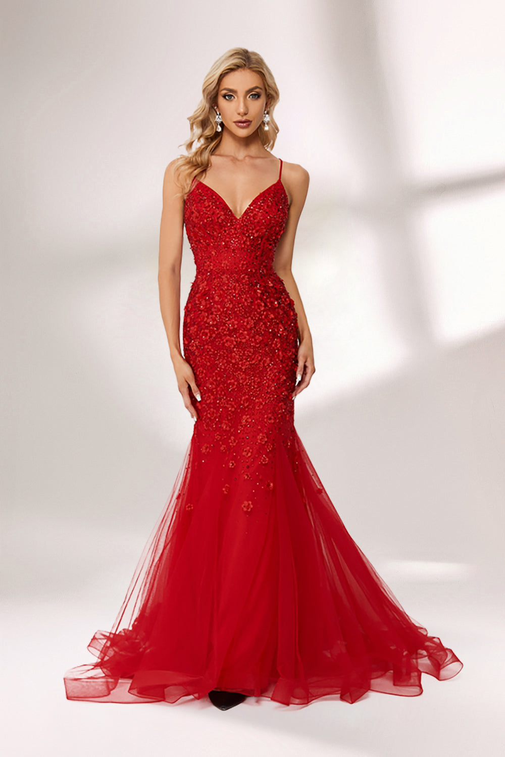 photo of beautiful blonde woman wearing elegant red evening gown with sequins, long fitted dress with sheer tulle skirt, standing in front of white background with soft shadows, light skin tone, wavy hair, red lipstick, confident pose, glamorous, high fashion, studio lighting, full body shot, no accessories except earrings, modern and chic style, full-length shot.KT1278C-05