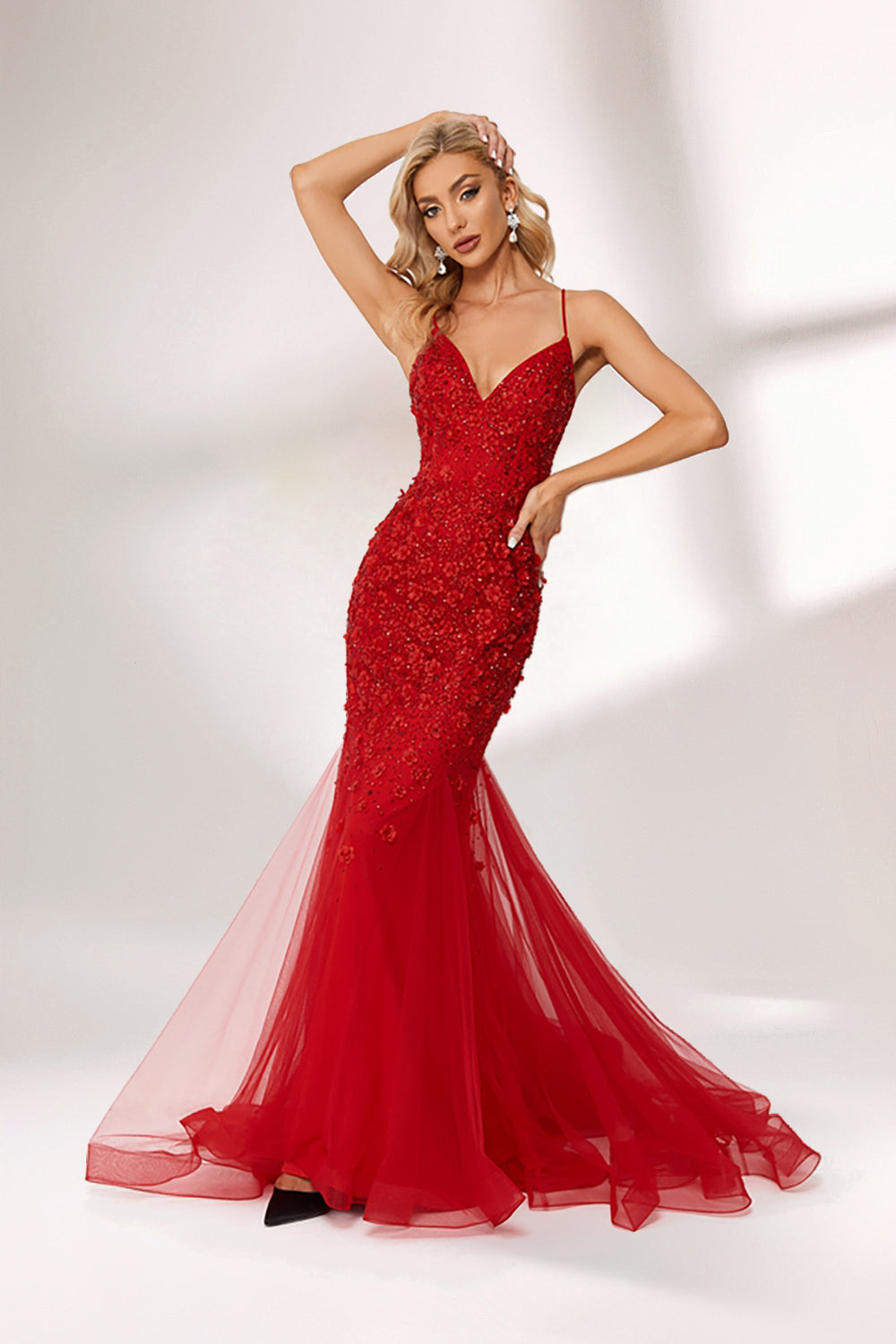 photo of beautiful blonde woman wearing elegant red evening gown with sequins, long fitted dress with sheer tulle skirt, standing in front of white background with soft shadows, light skin tone, wavy hair, red lipstick, confident pose, glamorous, high fashion, studio lighting, full body shot, no accessories except earrings, modern and chic style, full-length shot.KT1278C-06