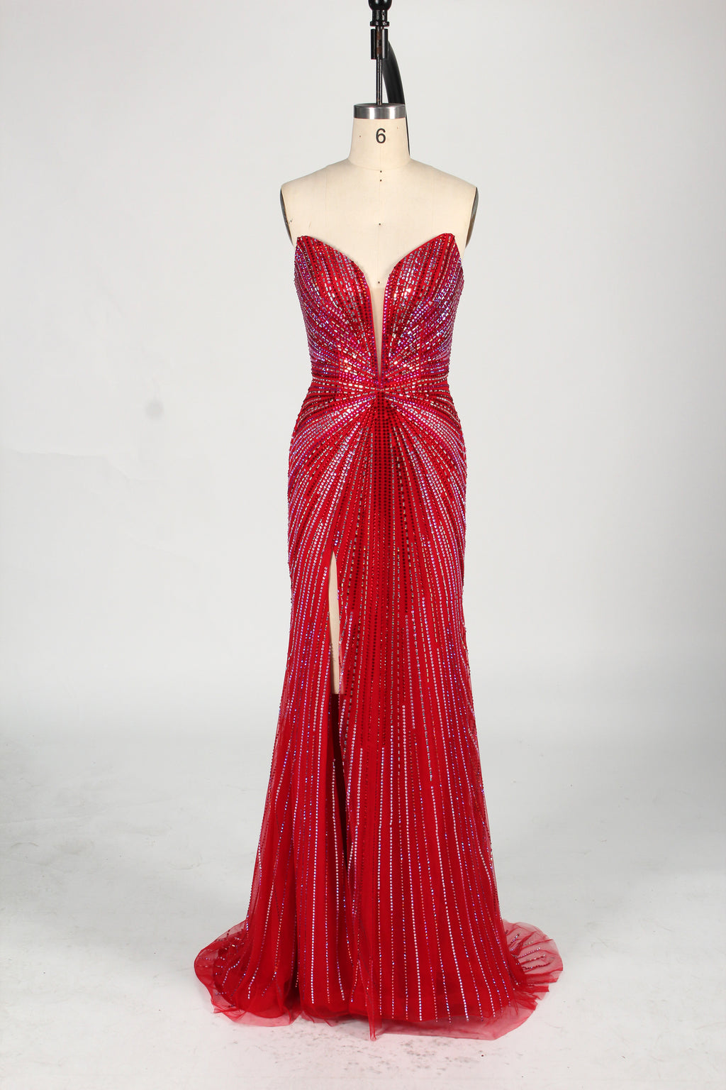 photo of a beautiful woman in a stunning blue ball gown with a plunging neckline and thigh-high slit, standing confidently in a studio with soft, diffused lighting, elegant and glamorous, full-length dress with intricate beadwork, long brunette hair styled in an elegant updo, fair skin, red lipstick, high heels, minimalist white background, fashion photography, stylish and sophisticated, no watermarks.KT1432-11
