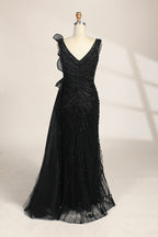 photograph of a mannequin wearing a stunning black evening gown, full-length, sleeveless, deep V-neck, intricate beadwork, flowing chiffon skirt, elegant, sophisticated, fashion, haute couture, runway model, high fashion, elegant design, detailed textures, luxurious, black and white, fashion photography, studio setting, plain background, soft lighting, shadow play, chic, elegant, classy, high-end fashion, glamour, haute couture fashion, evening wear.MC124-05