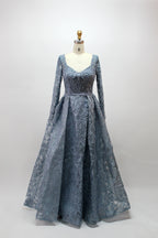Showcased on a mannequin is a silver - gray evening gown. It has a V - neckline, long sleeves, and intricate lace embroidery all over. The elaborate design gives off a luxurious and elegant vibe, ideal for formal occasions.4