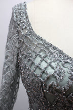 Showcased on a mannequin is a silver - gray evening gown. It has a V - neckline, long sleeves, and intricate lace embroidery all over. The elaborate design gives off a luxurious and elegant vibe, ideal for formal occasions.8