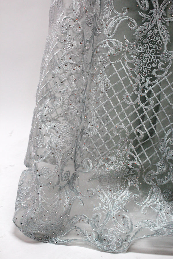 Showcased on a mannequin is a silver - gray evening gown. It has a V - neckline, long sleeves, and intricate lace embroidery all over. The elaborate design gives off a luxurious and elegant vibe, ideal for formal occasions.9