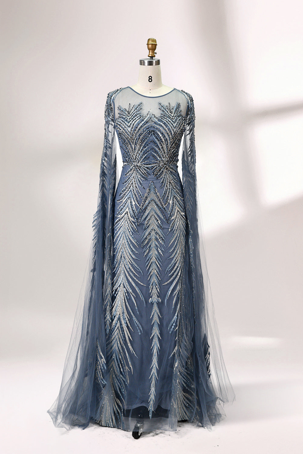 Showcased on a mannequin is a light - teal evening gown. It features a sheer high - neck design, long flowing sleeves, and intricate leaf - pattern embroidery. The gown's elegant and unique design exudes a sense of sophistication and grace, making it an ideal choice for formal events.
5