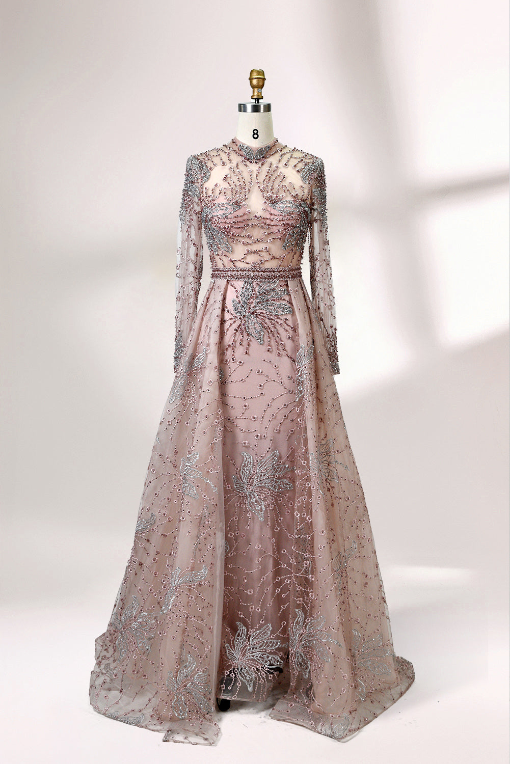 Presented on a mannequin is a blue - toned evening gown. It has a high neckline, long sheer sleeves, and intricate floral embroidery. The elegant design gives off a luxurious and sophisticated vibe, ideal for formal occasions.5
