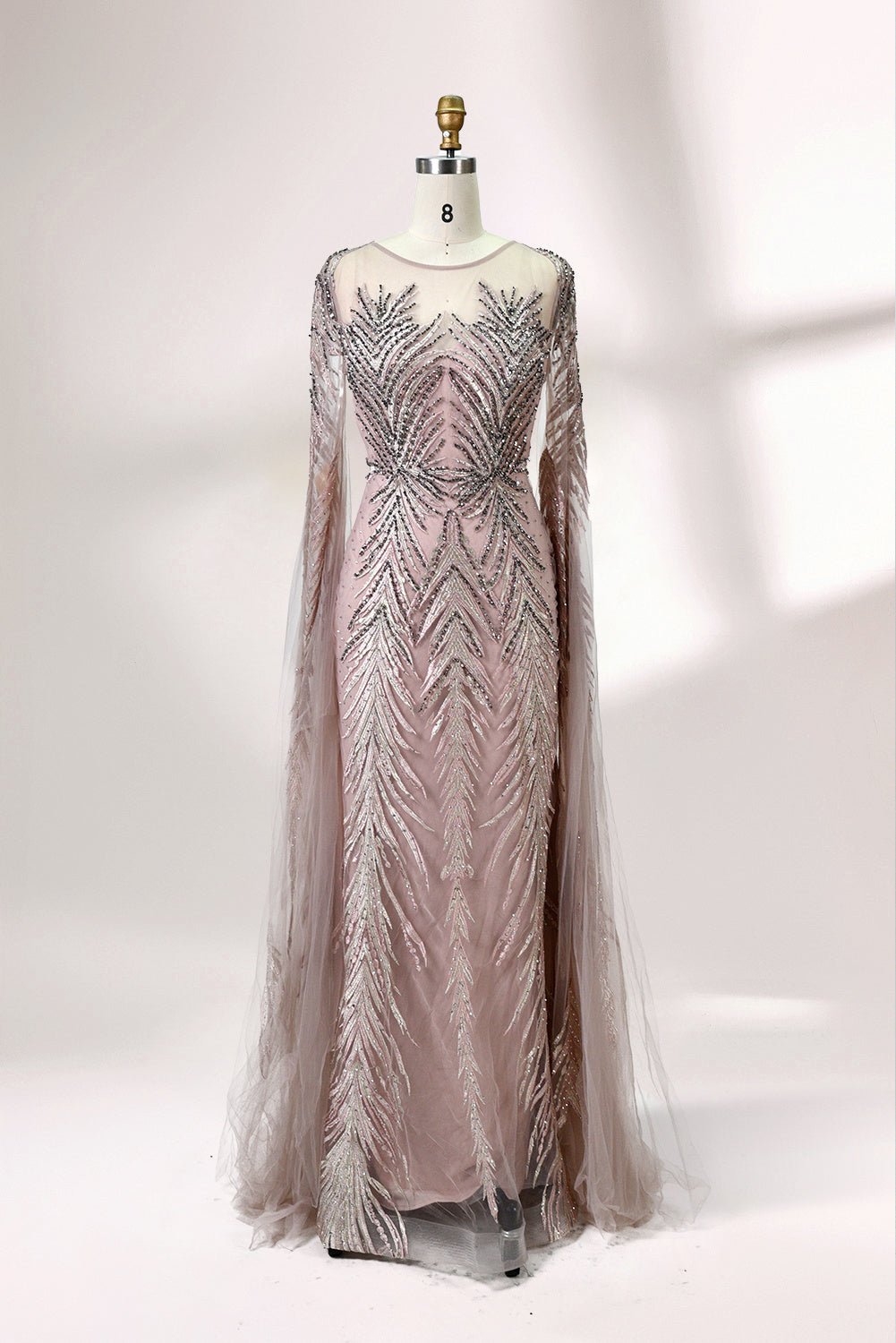 Showcased on a mannequin is a light - teal evening gown. It features a sheer high - neck design, long flowing sleeves, and intricate leaf - pattern embroidery. The gown's elegant and unique design exudes a sense of sophistication and grace, making it an ideal choice for formal events.
7