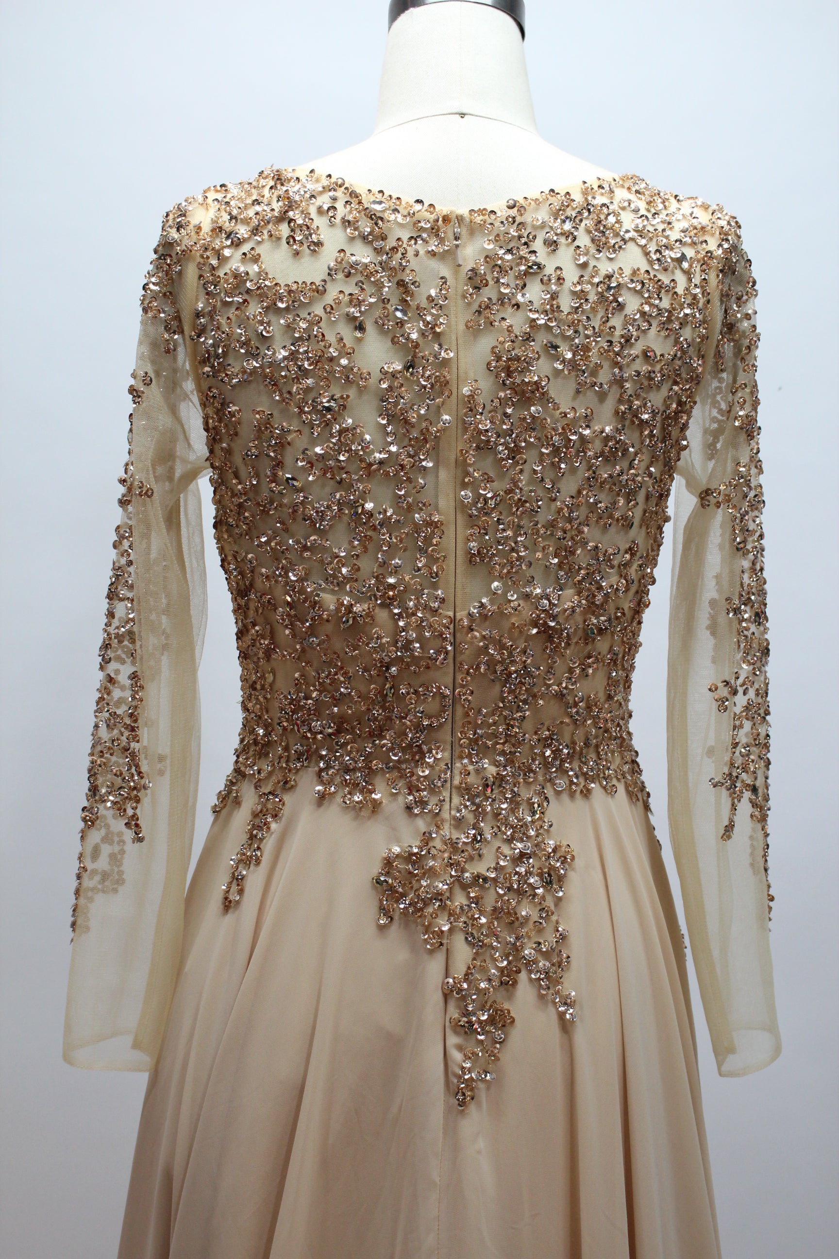 Elegant champagne-gold mother of the bride dress featuring a scoop neck, sheer long sleeves with sequin embroideries, and a flowing long A-line chiffon skirt.