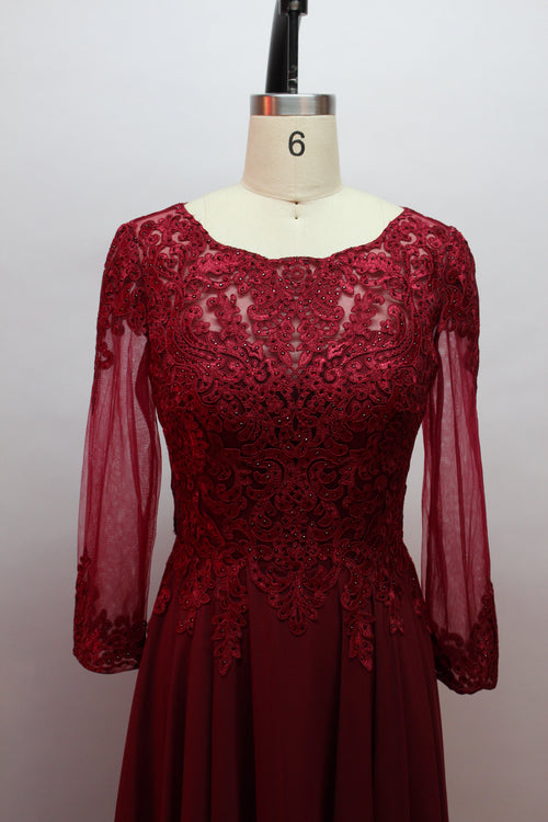 Front view of an elegant burgundy A-line mother of the bride dress featuring a scoop neck bodice with intricate beaded lace detailing, sheer long chiffon sleeves, and a long flowing floor-length chiffon skirt, suitable for weddings and formal evening galas and available for wholesale or bulk purchase.
