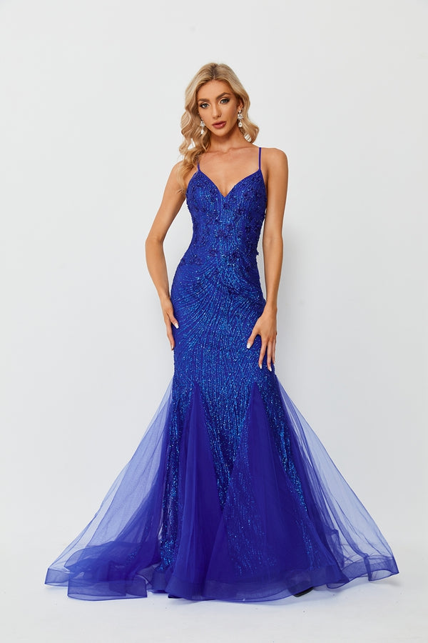 A beautiful woman in a glamorous blue sequin evening gown, standing against a plain white background, elegant pose, hand on hip, other hand touching head, long blonde wavy hair, fair skin, red lipstick, floor-length dress, fitted bodice, flared skirt, sheer tulle, sequin details, sophisticated and classy, high-fashion, full-length shot, minimalistic background, studio lighting, no watermark